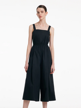 a lady wears a black gathered waist jumpsuit